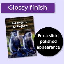 Load image into Gallery viewer, Greeting card with two monkeys and text 'Like mother, like daughter' on a wooden background. A purple banner at the top that says, "Glossy finish" and a black circle with text that says, "For a slick, polished appearance."