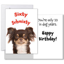 Load image into Gallery viewer, Humorous 60th birthday card featuring a long-haired chihuahua on the front with the words &#39;Sixty Schmixty&#39; in bold red letters. Inside, the message reads &#39;You&#39;re only 10 in dog years. Happy Birthday!&#39; The card comes with a smooth, writable surface inside and a white envelope for mailing.
