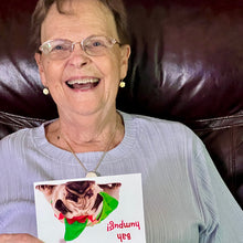 Load image into Gallery viewer, Woman laughing while receiving the cute &#39;Bah humpug!&#39; birthday card, perfect for friends and family.
