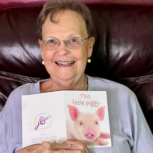 Woman smiling while receiving the cute 'This little piggy' birthday card, perfect for friends and family.