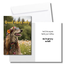 Load image into Gallery viewer, A greeting card with a hippie Irish setter sitting in a field of flowers, wearing a crown of flowers and round glasses. The front says, &quot;Good vibes only&quot; The inside says, &quot;Don&#39;t let anyone harsh your mellow. You&#39;re groovy as hell!&quot; Includes a white envelope.
