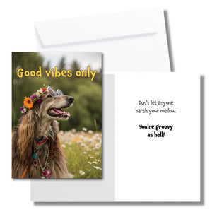 A greeting card with a hippie Irish setter sitting in a field of flowers, wearing a crown of flowers and round glasses. The front says, "Good vibes only" The inside says, "Don't let anyone harsh your mellow. You're groovy as hell!" Includes a white envelope.
