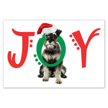 Load image into Gallery viewer, Christmas card with the word JOY across the front with a schnauzer dog  putting his head through the O in JOY. The J and Y are in red font and the O is in green. Each letter has some decorative dots.  
